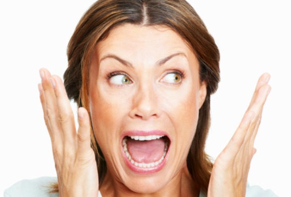 Closeup of shocked woman over white background